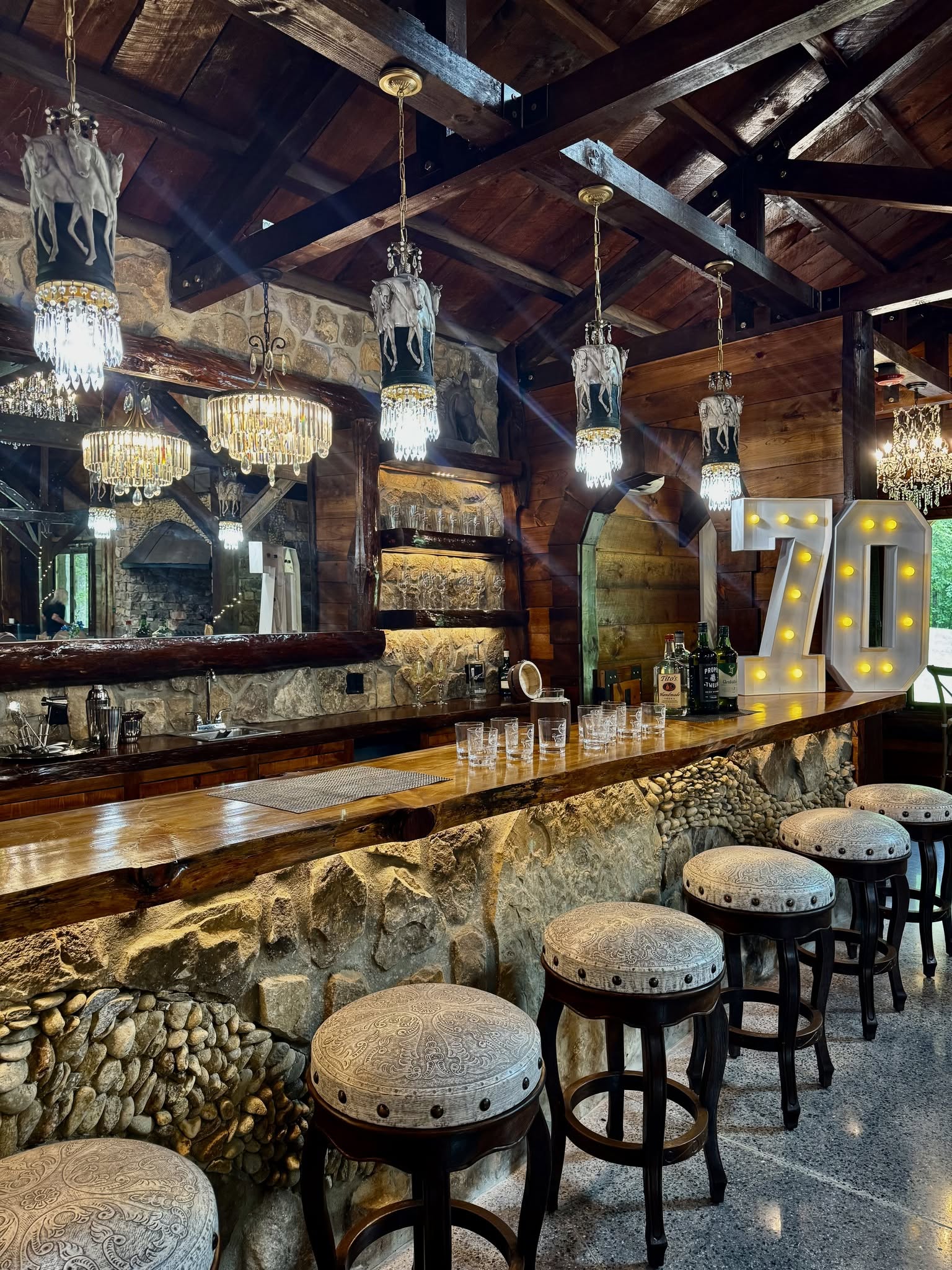 Rustic stone bar with crystal chandeliers